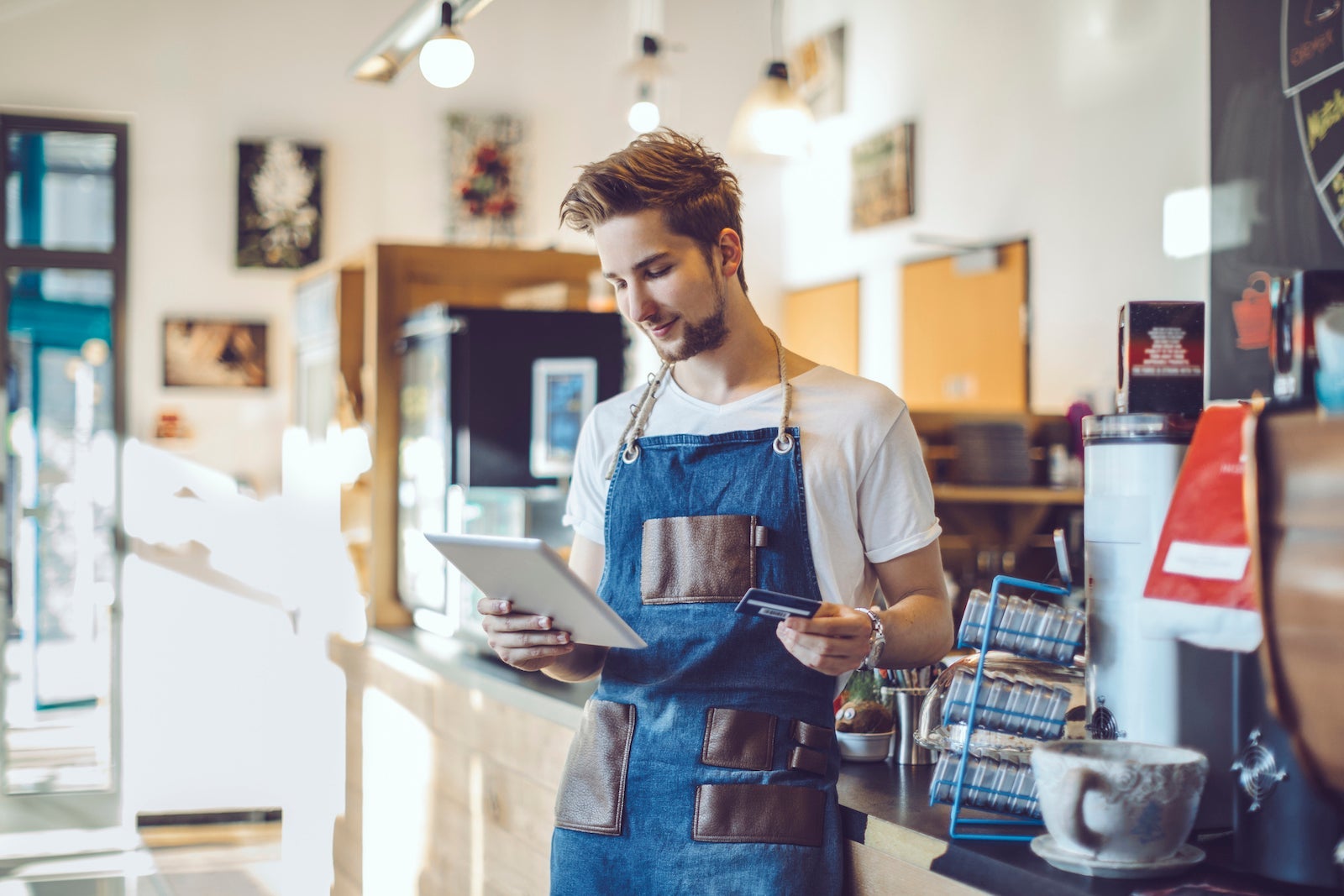 Young barista is working in a café