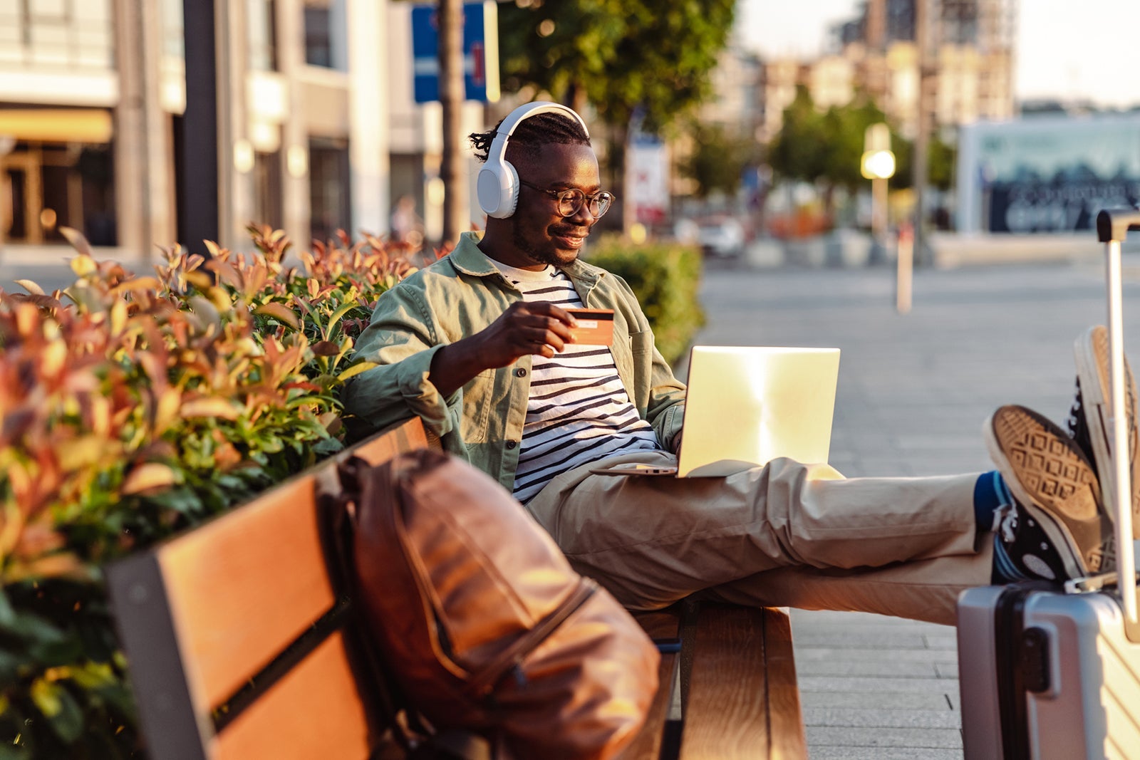Young male tourist buying tickets online