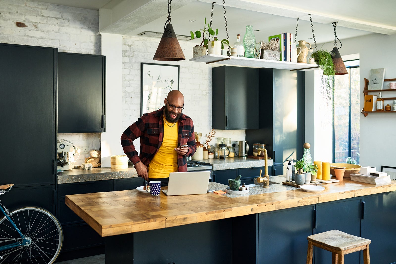 Cheerful black freelancer in kitchen on video call, smiling