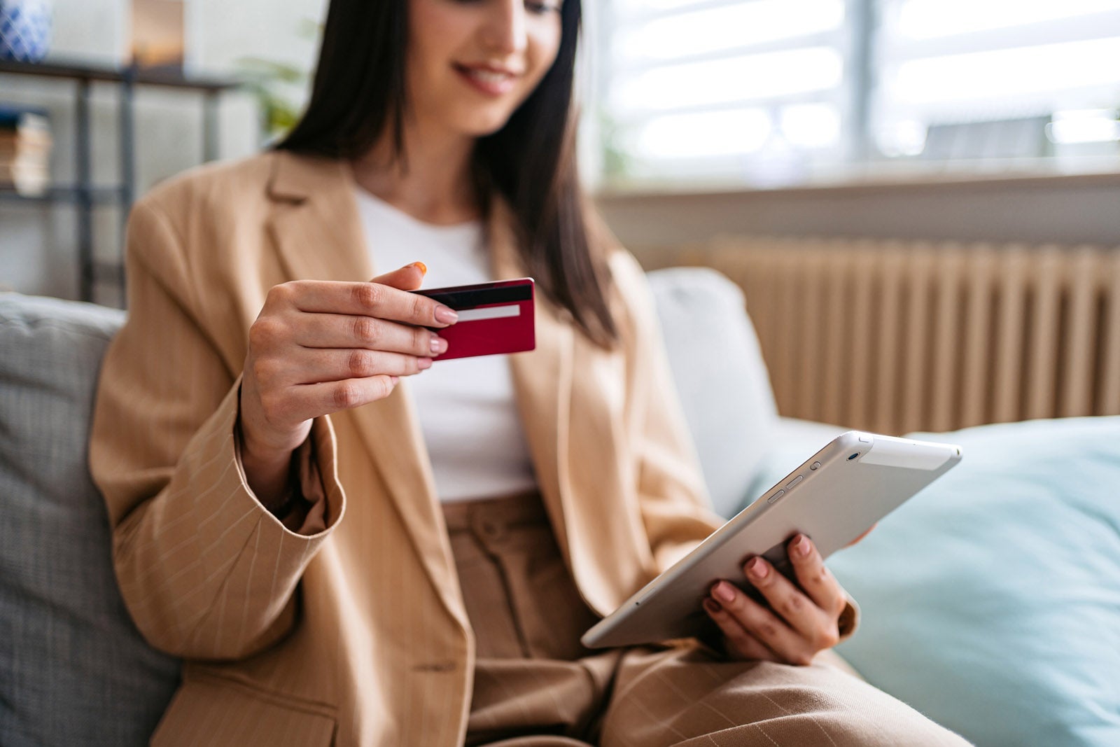 Woman Shopping Online Using Digital Tablet At Home