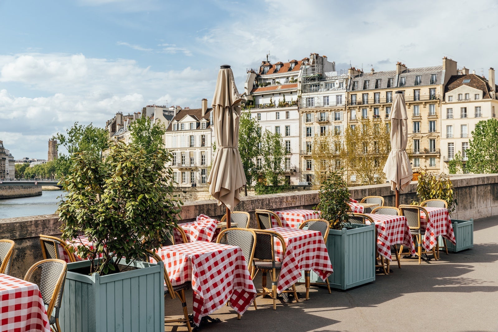 Cafe on the bank of the Seine river on a sunny day, Paris, France